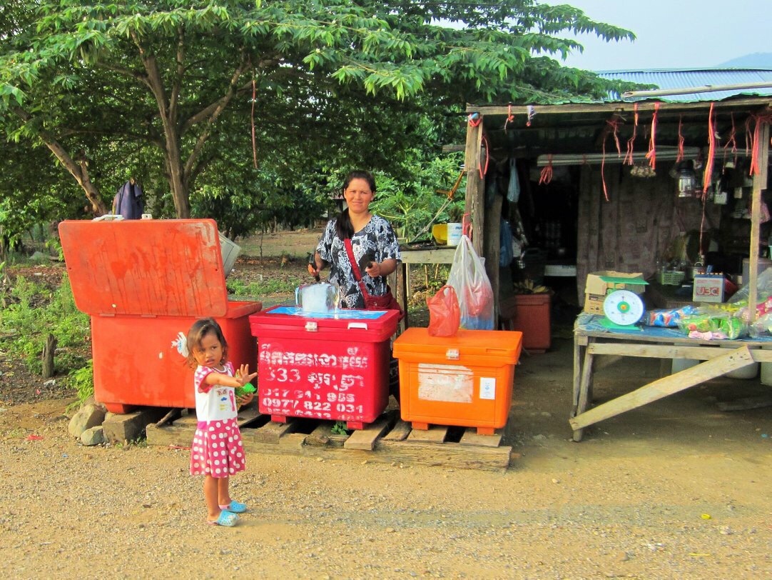 Local kids waving as we cycle by